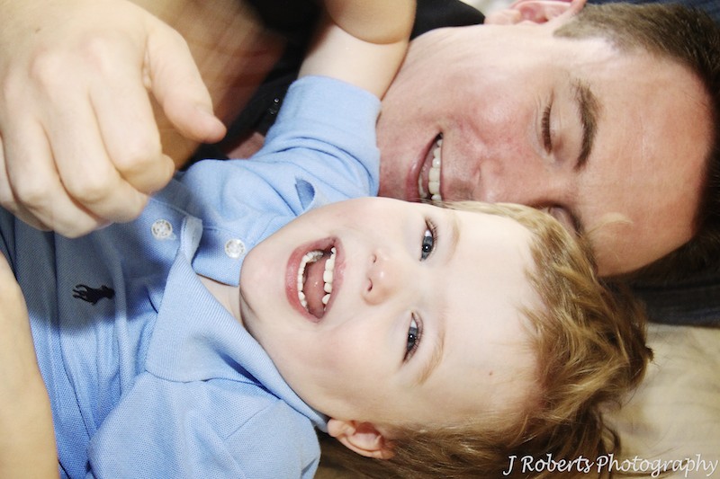 Father and son having rumbles - family portrait photography sydney